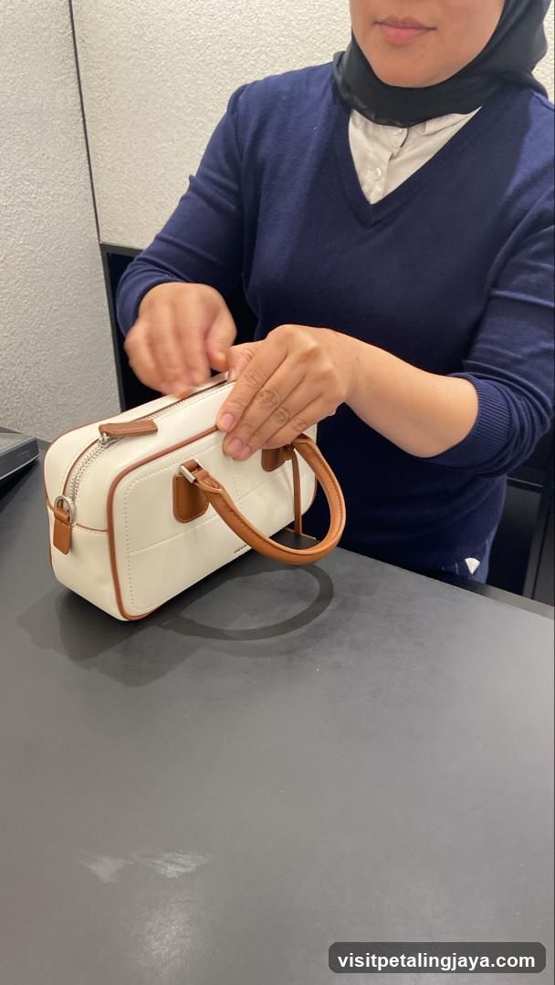 Person Handling a White Handbag
