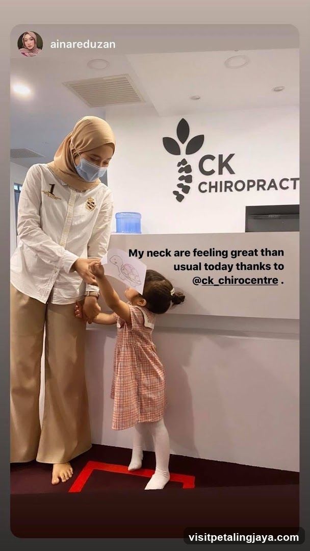 Chiropractor with child at reception desk