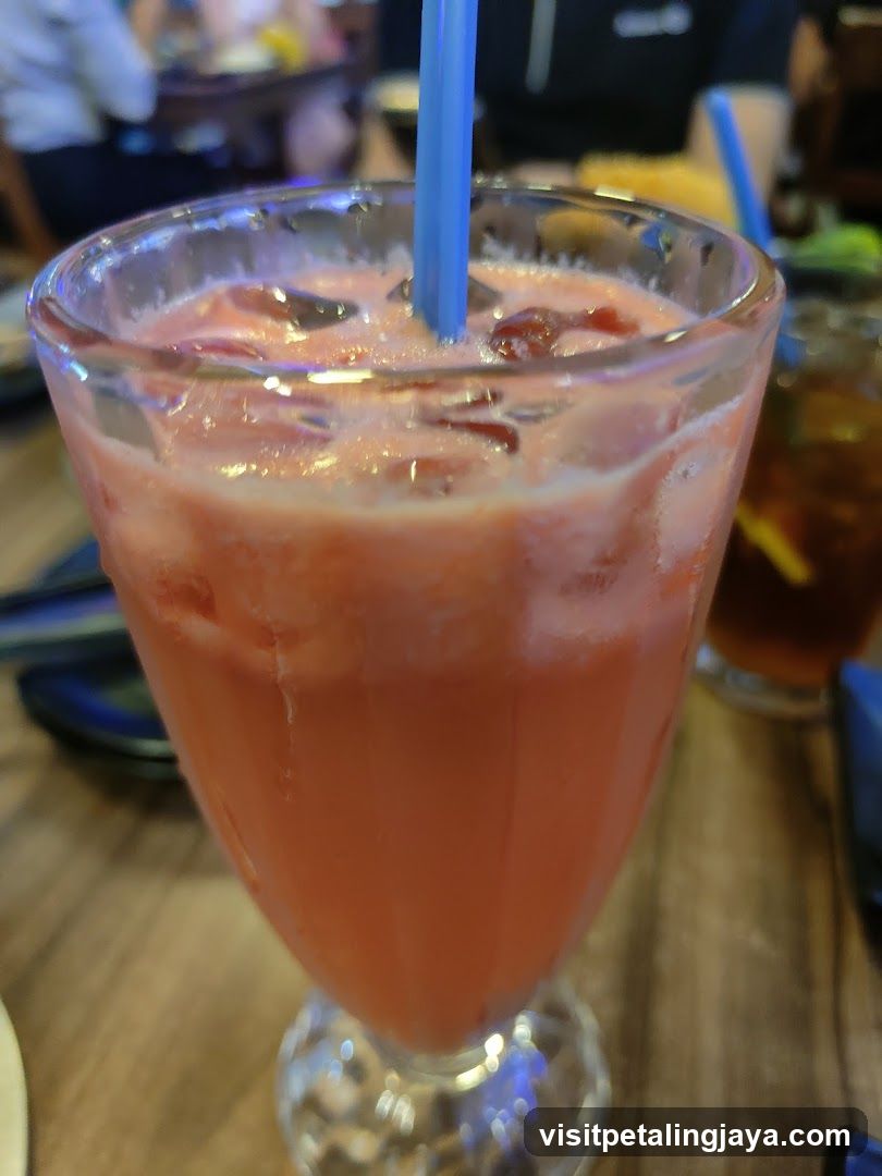 Pink Iced Drink with Blue Straw