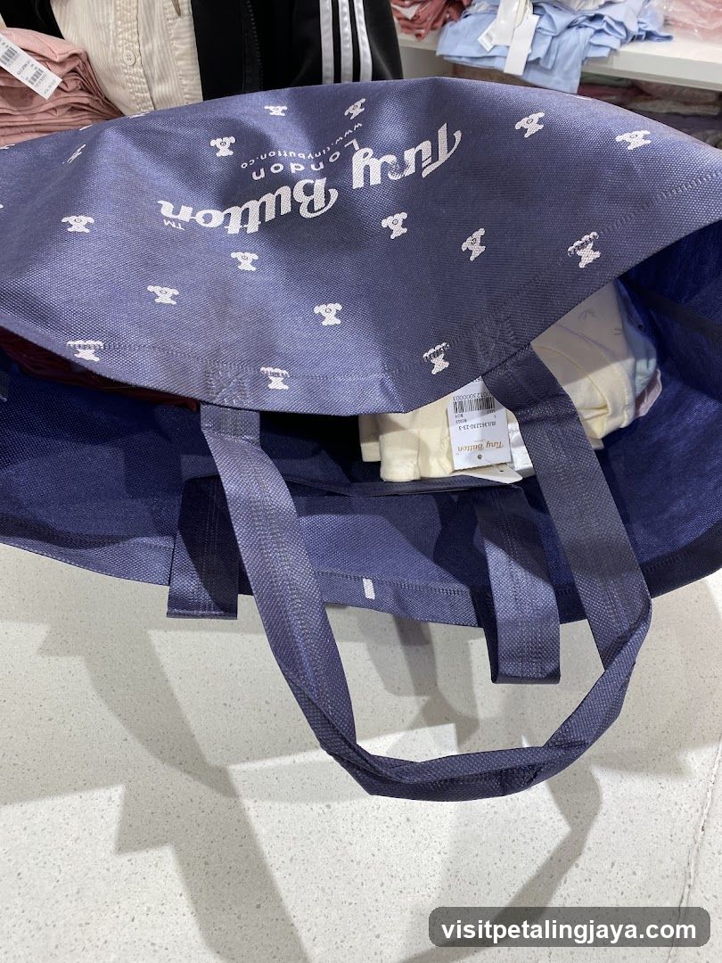 Tory Button tote bag with clothing inside