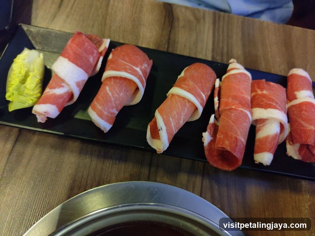 Raw Meat Slices on Black Plate