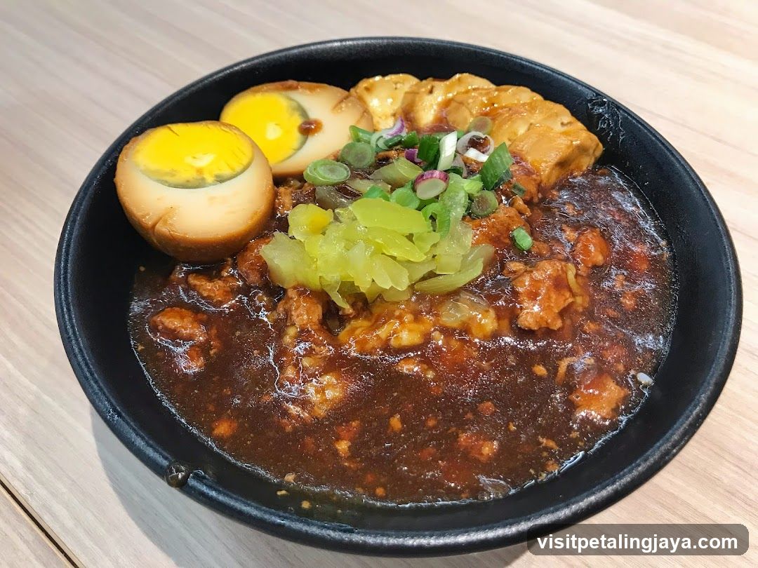 Bowl of Spicy Meat Sauce with Pickles and Egg