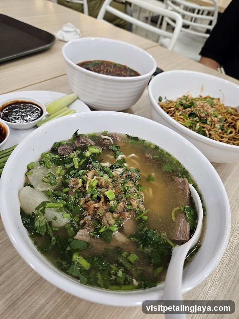 Bowl of Soup with Noodles and Side Dishes