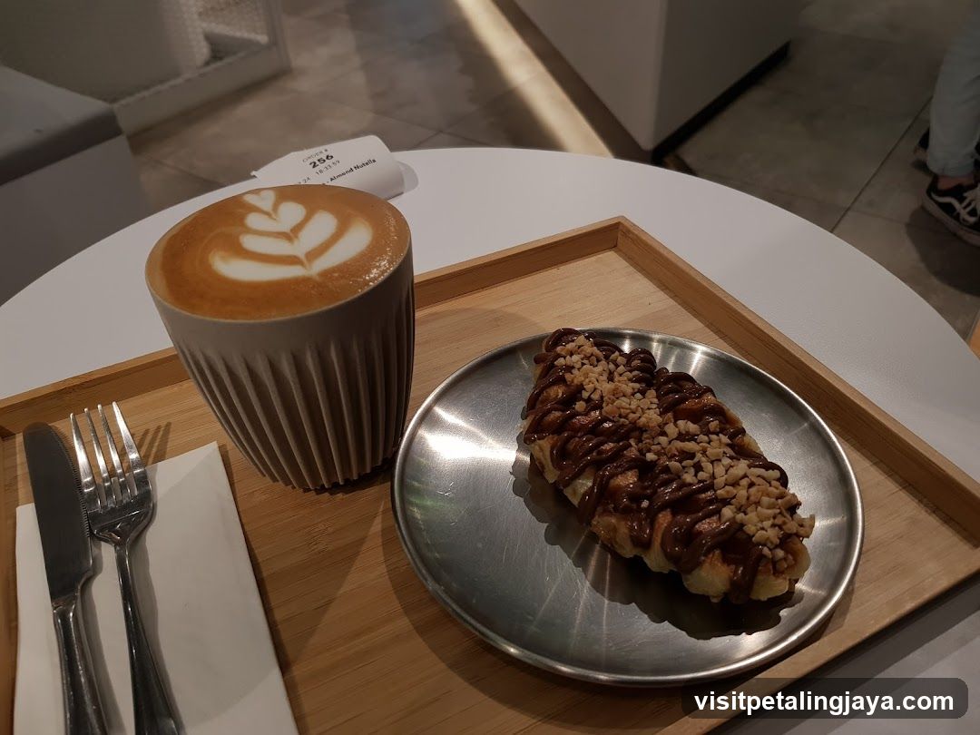 Latte and Pastry on Wooden Tray