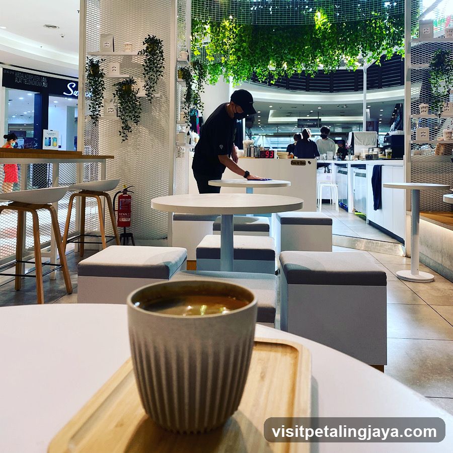 Coffee Shop Interior with Staff Serving