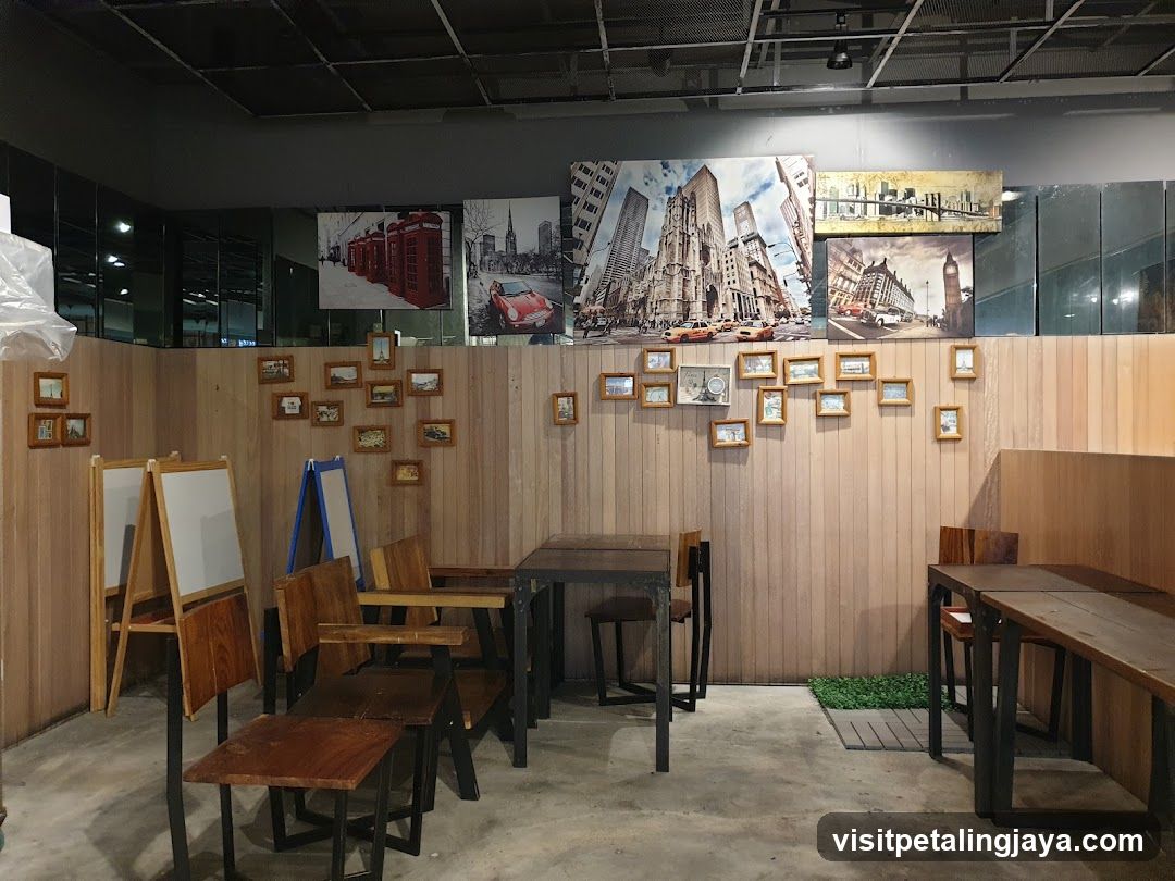 Interior of a cafe or restaurant with wooden decor and framed photos on walls.