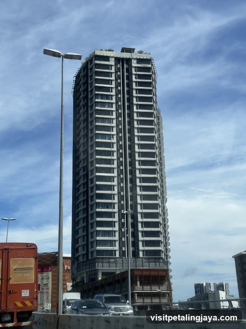 High-rise building exterior with vehicles in foreground