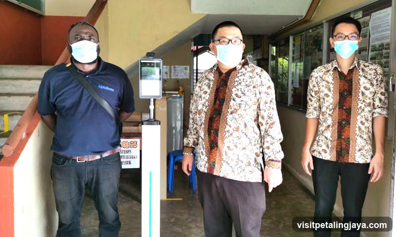 Staff with Face Scanner at Entrance