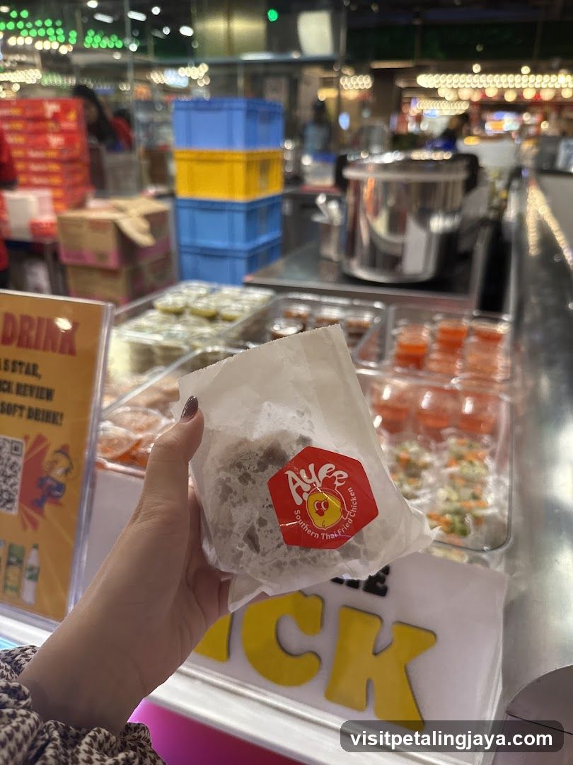 Hand holding food item at food stall