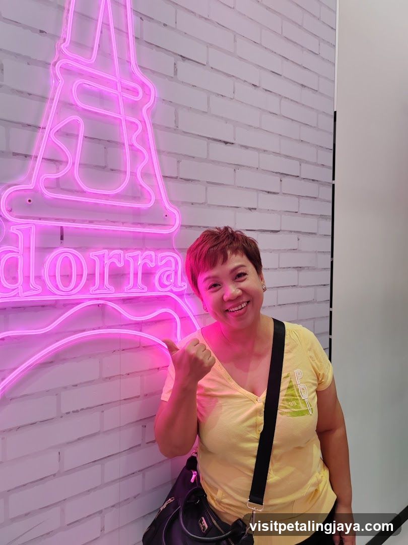 Person posing with neon sign