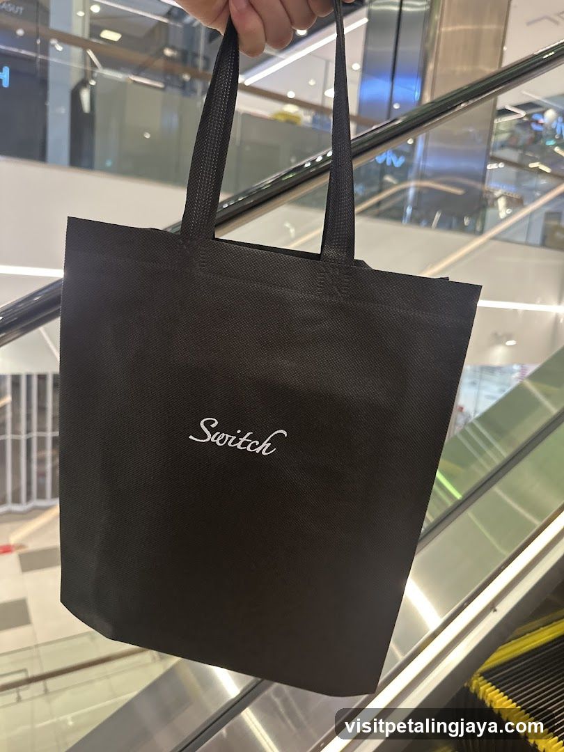 Black tote bag with 'Switch' logo