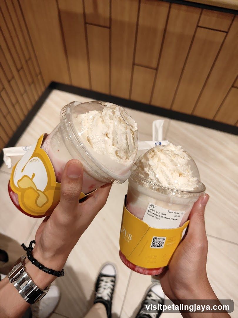 Two Frozen Dessert Drinks Held Up