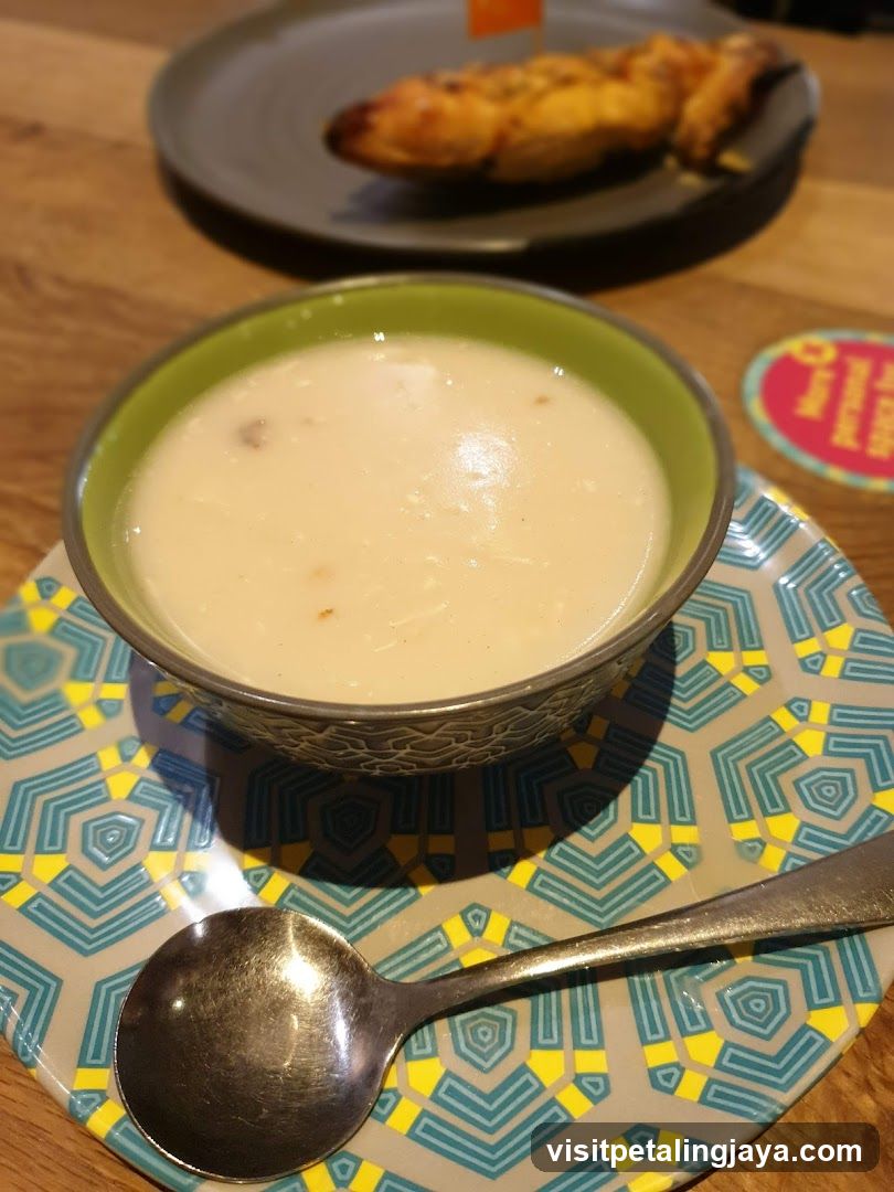 Bowl of Creamy Soup with Side Dish