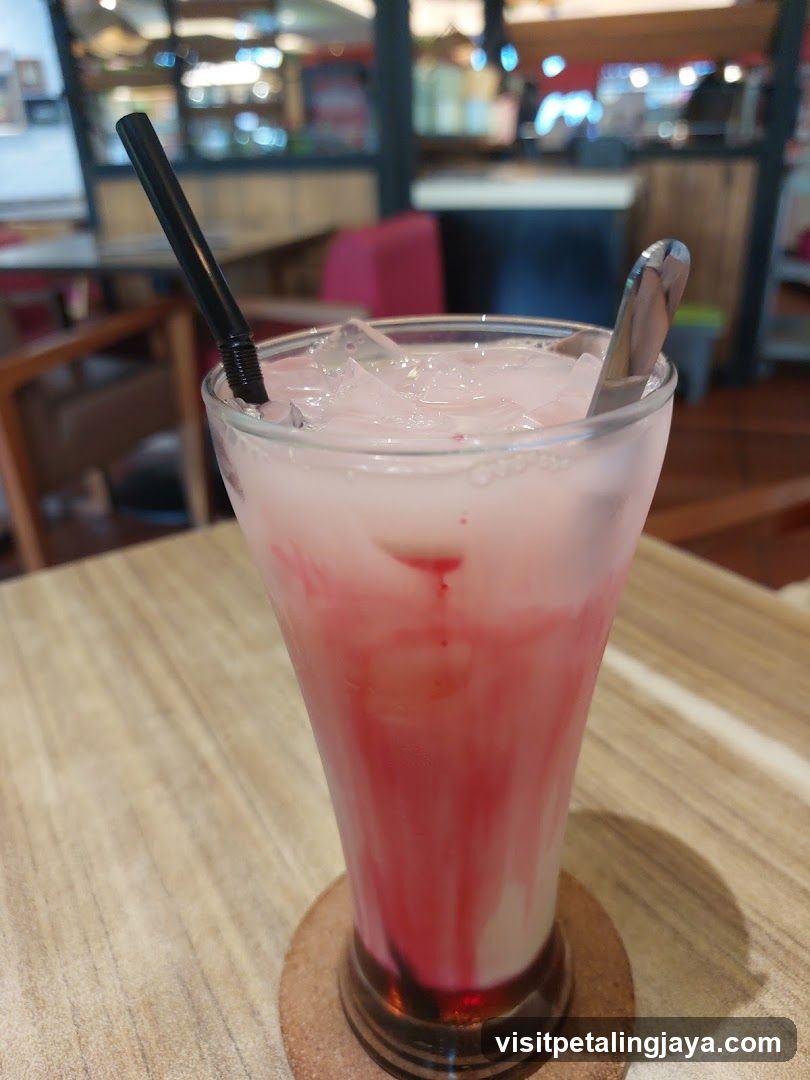 Pink Iced Drink with Straw and Spoon