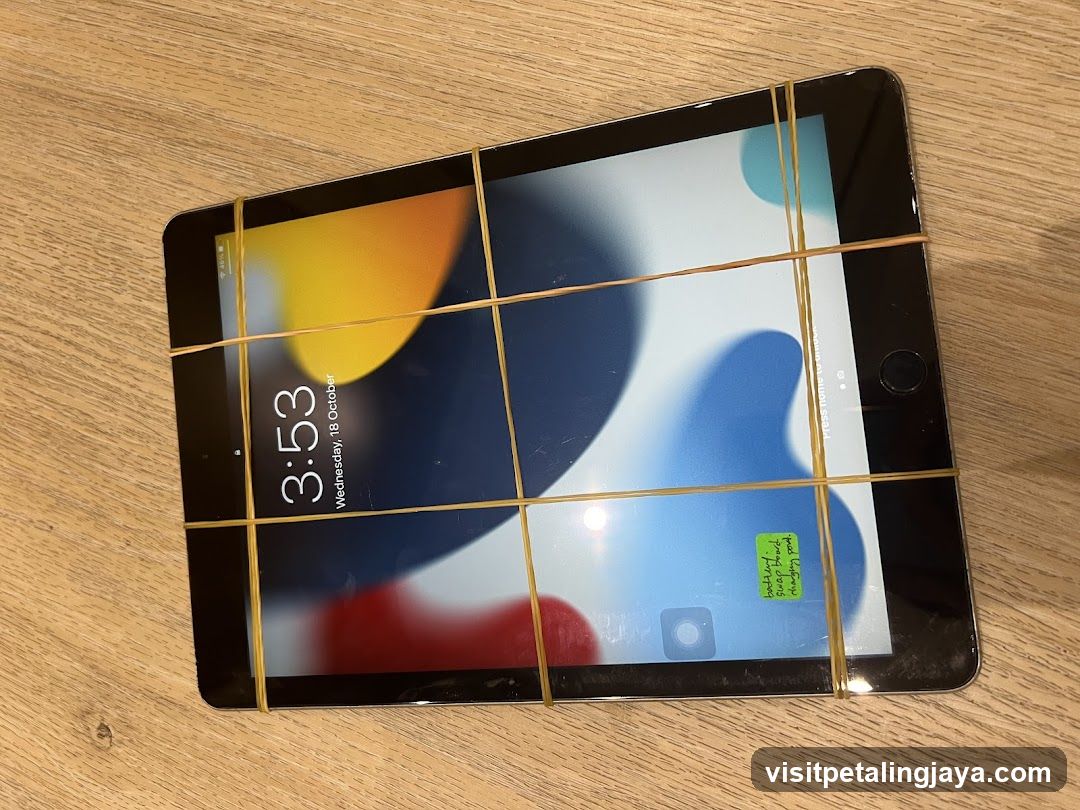 iPad with rubber bands on screen