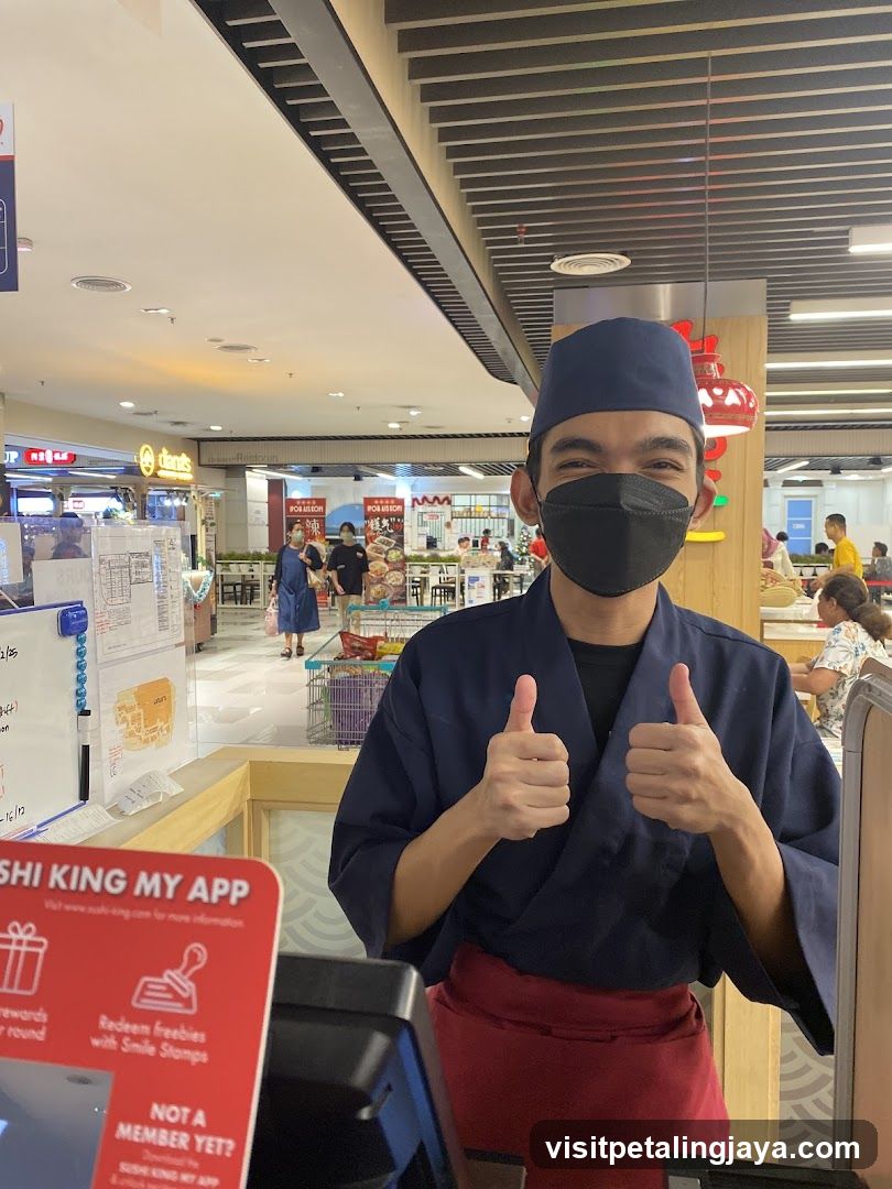 Staff giving thumbs up in mall food court