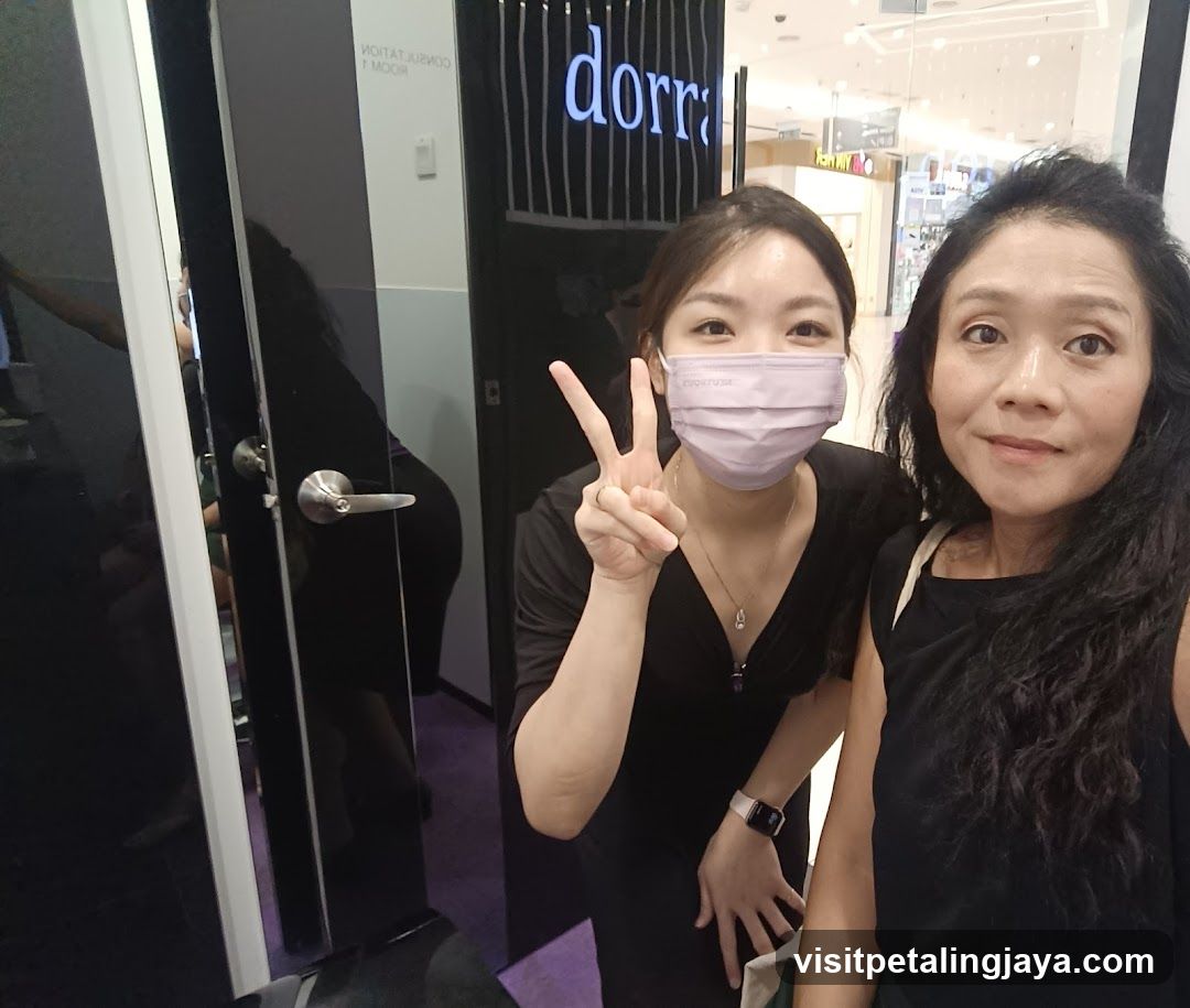 Two women posing in a store entrance
