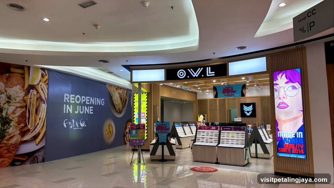 Shopping Mall Interior with Storefronts and Advertisements