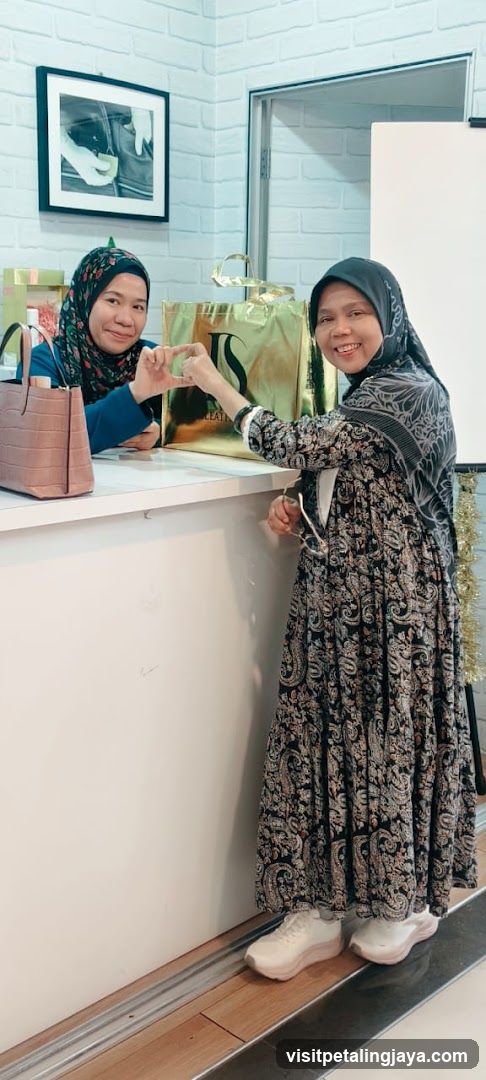 Two women posing with shopping bags at a counter