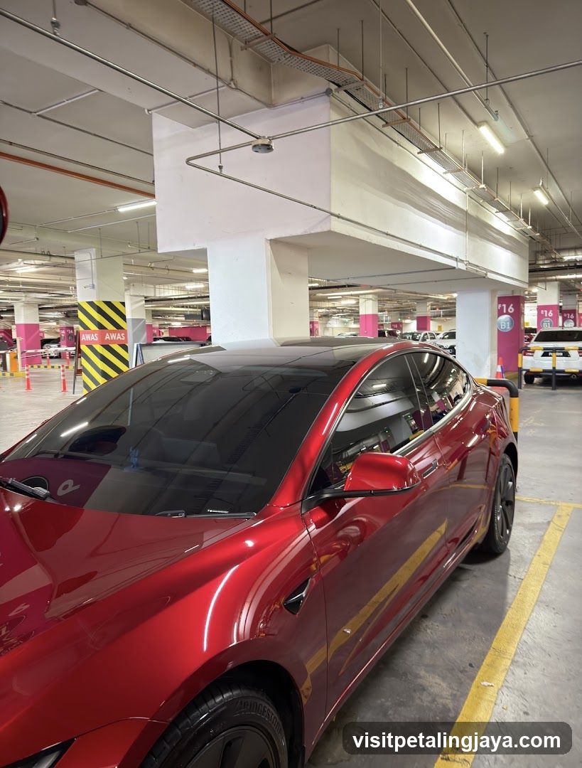 Red Tesla in Parking Garage