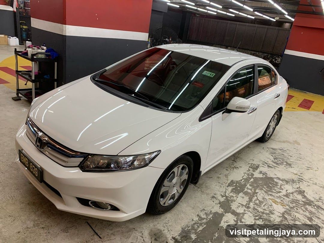 White Honda Civic in a garage or workshop