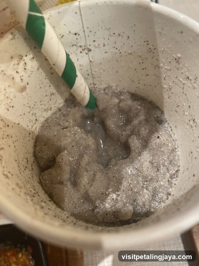 Bowl of Grey Sludge with Straw