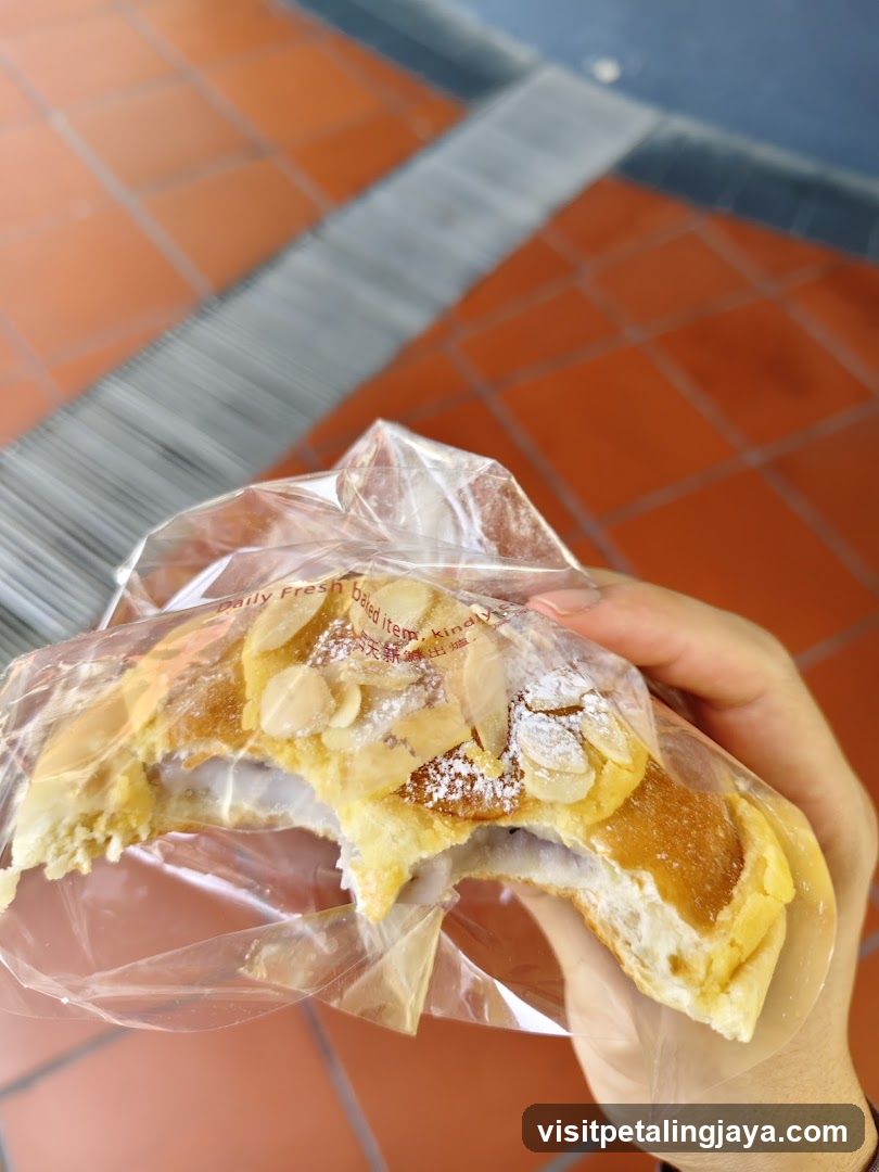 Hand holding a partially eaten pastry