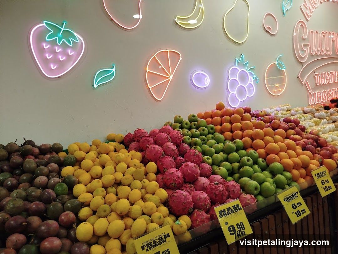 Fruit Display with Neon Signs