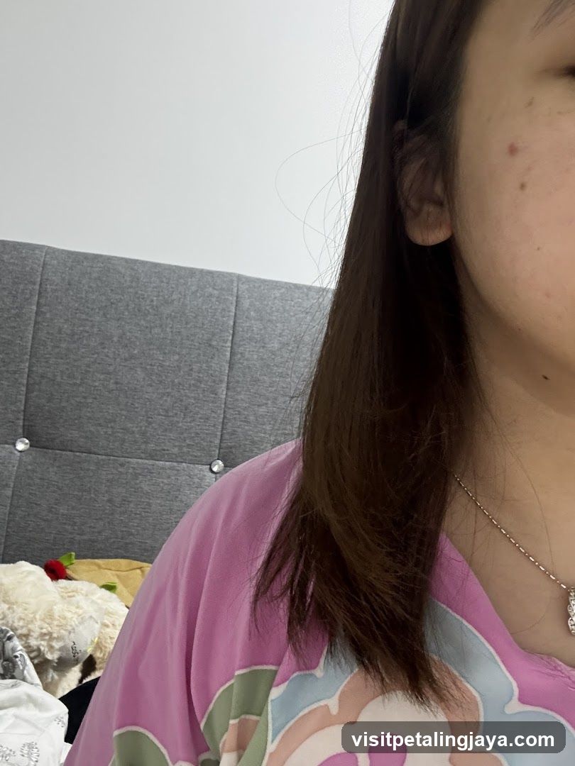 Person in pink shirt indoors