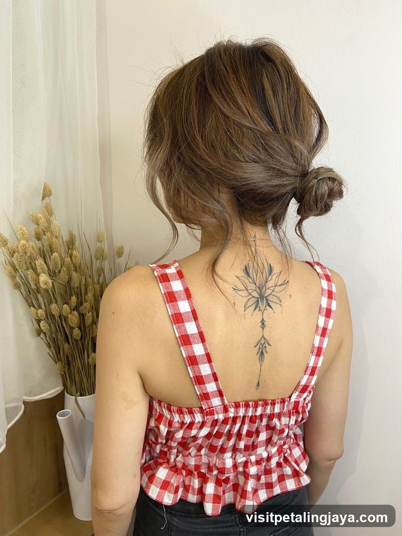 Woman with Bun and Back Tattoo