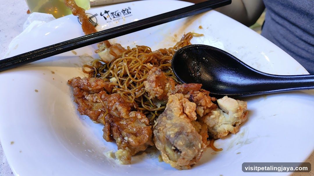 Fried Chicken and Noodles with Chopsticks and Spoon