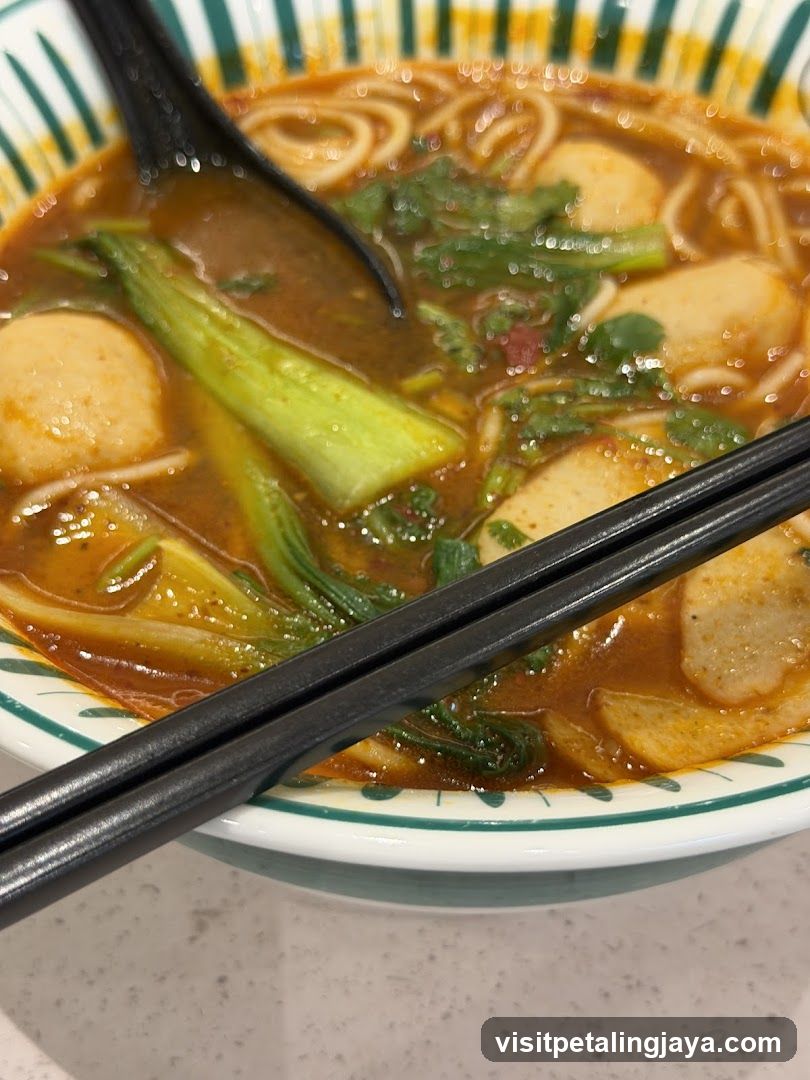 Bowl of Noodle Soup with Fish Balls and Greens
