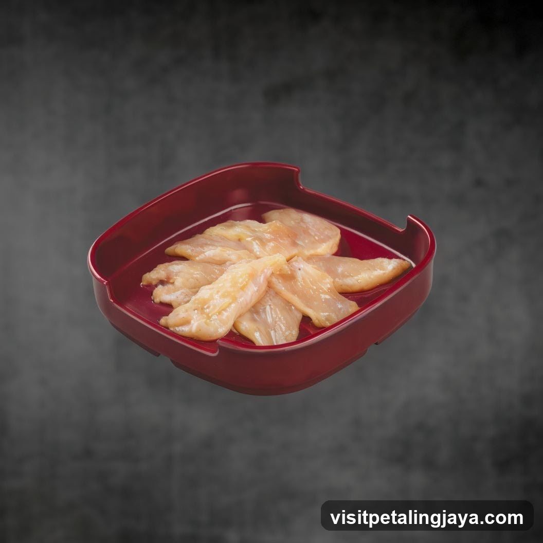 Raw Chicken Strips in Red Dish