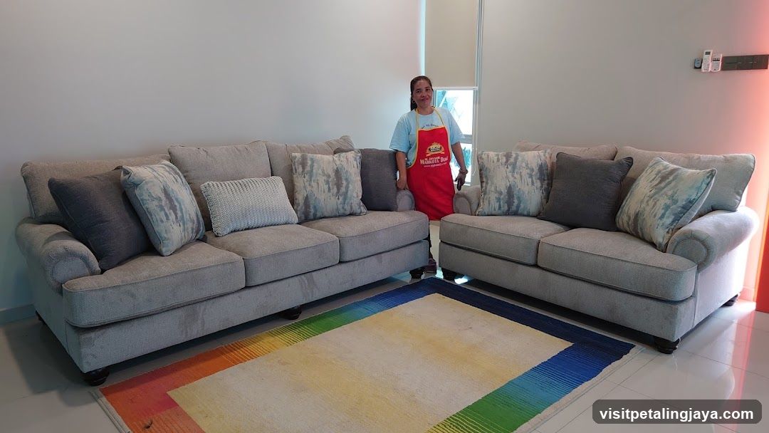 Living Room with Sofas and Staff Member