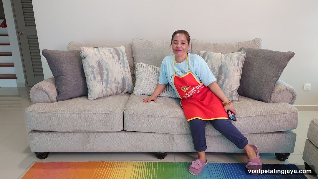 Woman in Apron Sitting on Sofa