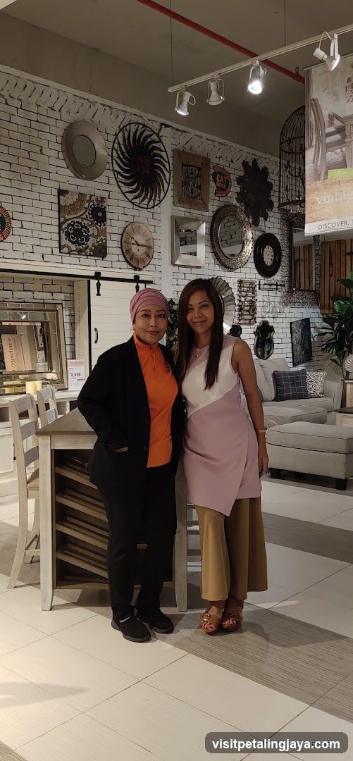Interior of a furniture store with two women posing