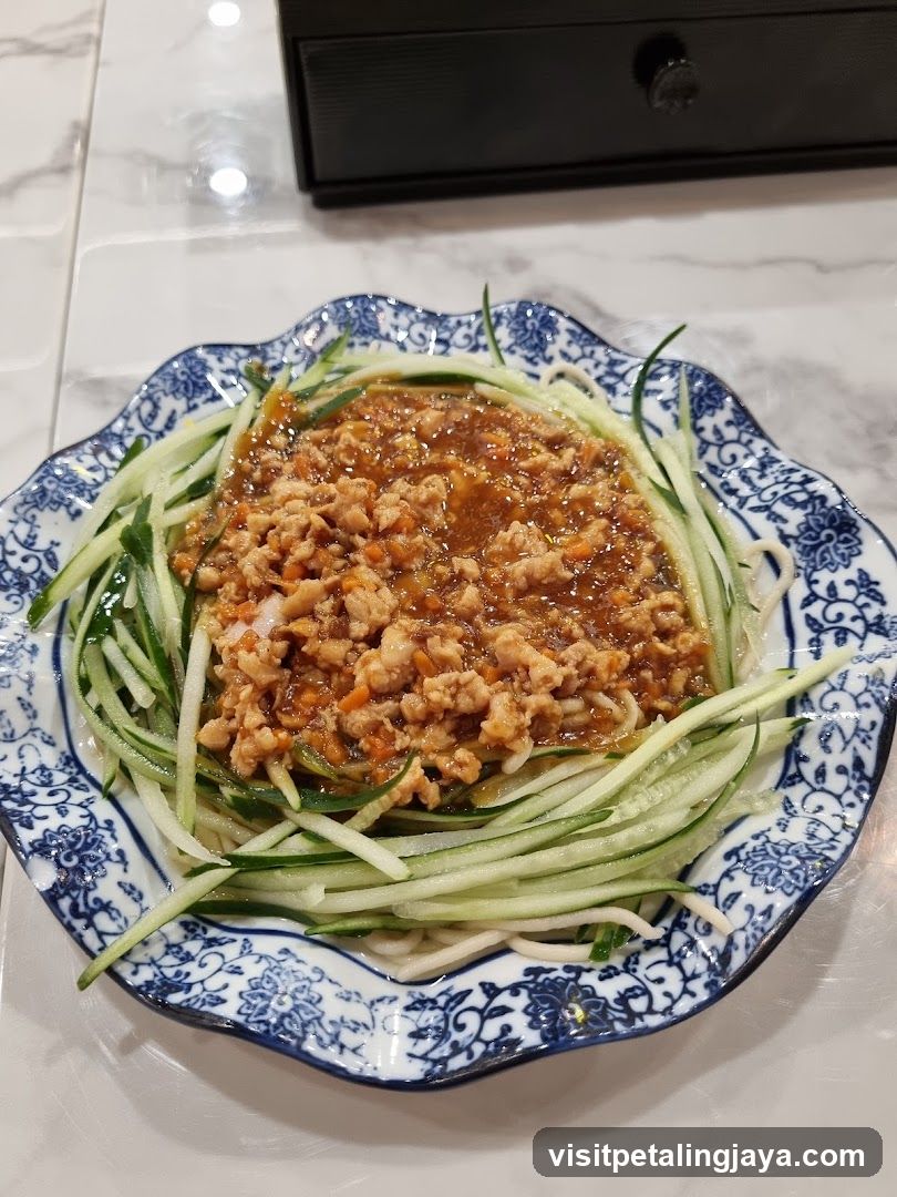 Dish with minced meat sauce and cucumber strips