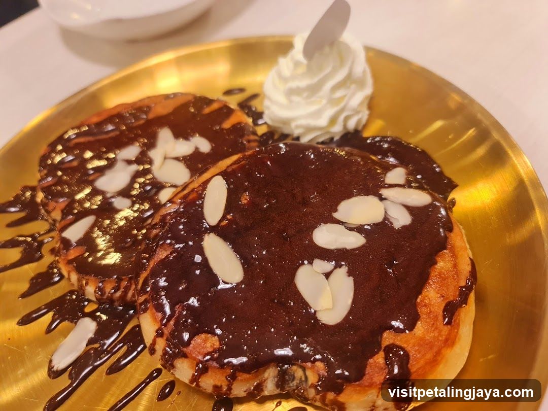 Chocolate Pancakes with Almonds and Whipped Cream