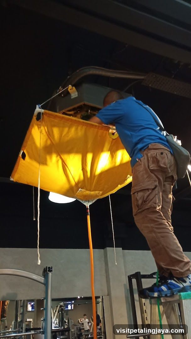 Worker installing yellow light fixture