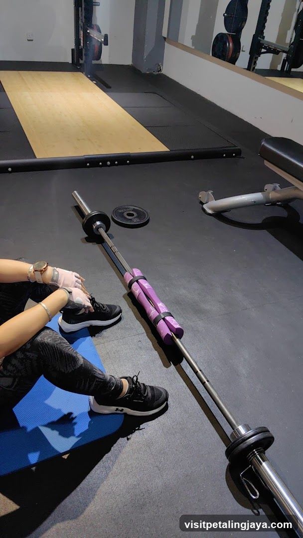 Gym Interior with Barbell and Person Preparing to Lift
