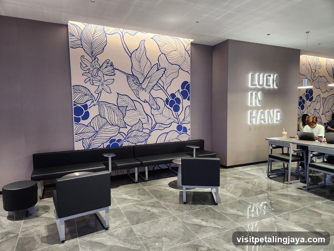 Interior seating area with floral wall art and illuminated sign