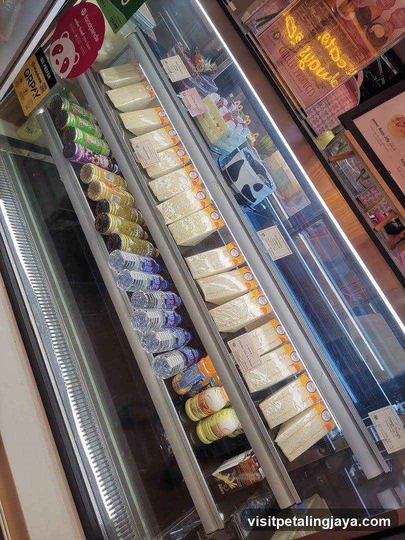 Refrigerated Display Case with Beverages and Cakes