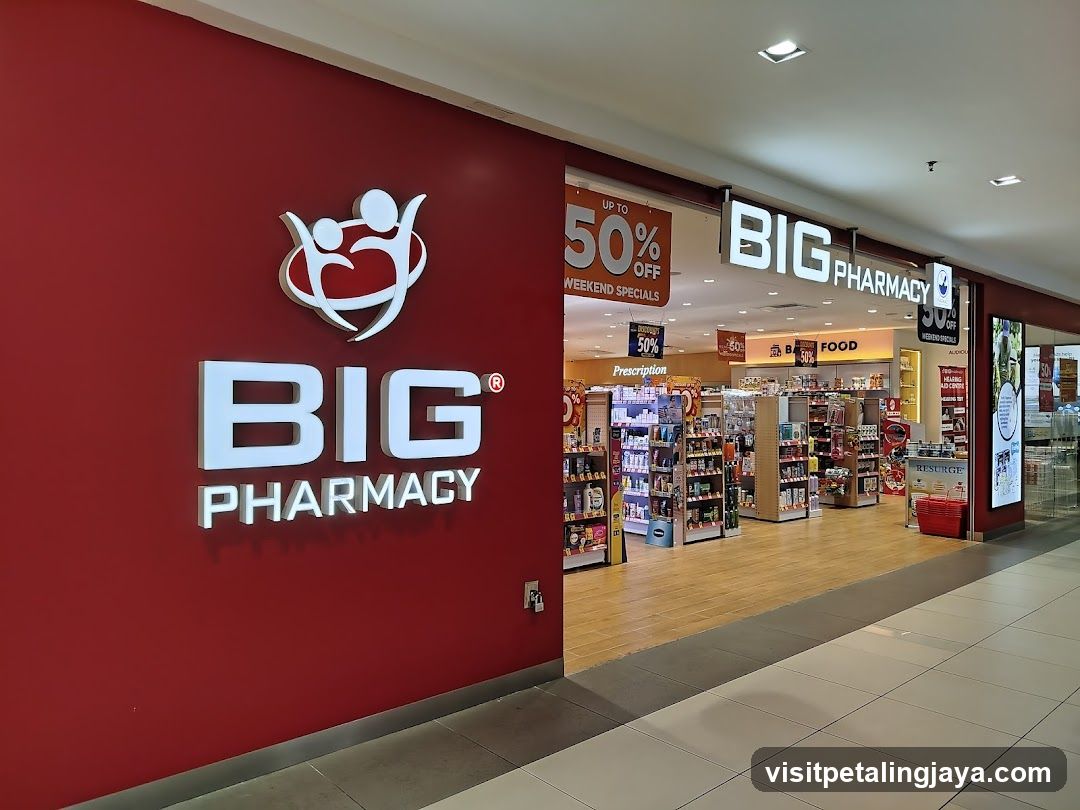 A red wall with the Big Pharmacy logo and signage, showing an entrance to a pharmacy store inside a mall.