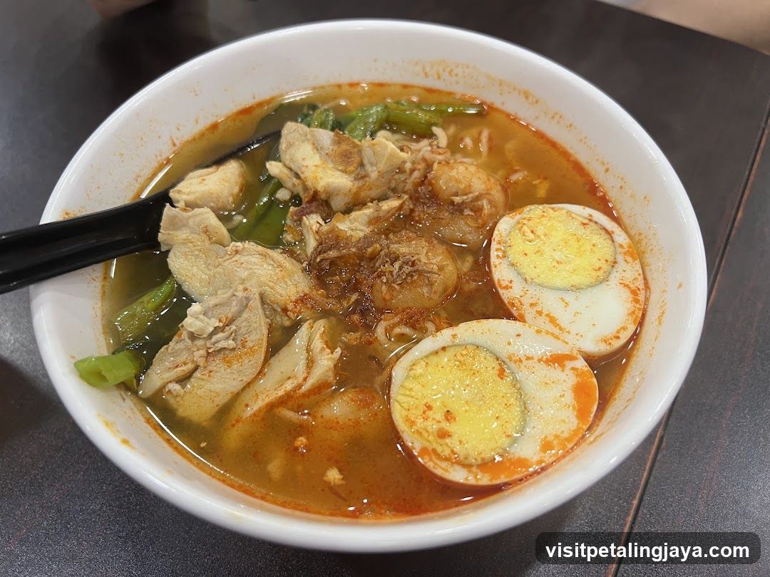 Bowl of Spicy Noodle Soup with Chicken and Boiled Eggs
