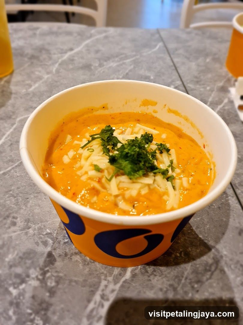 Bowl of Orange Soup with Cheese and Parsley