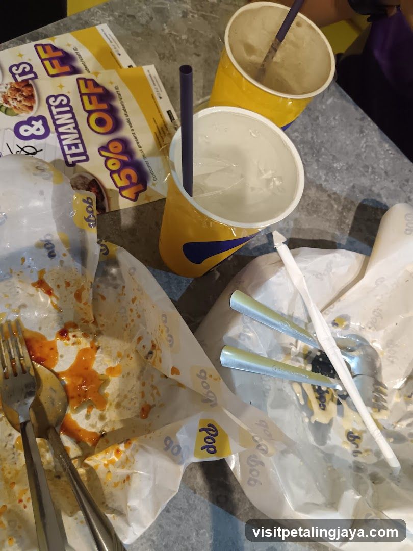 Used food wrappers and drinks on table
