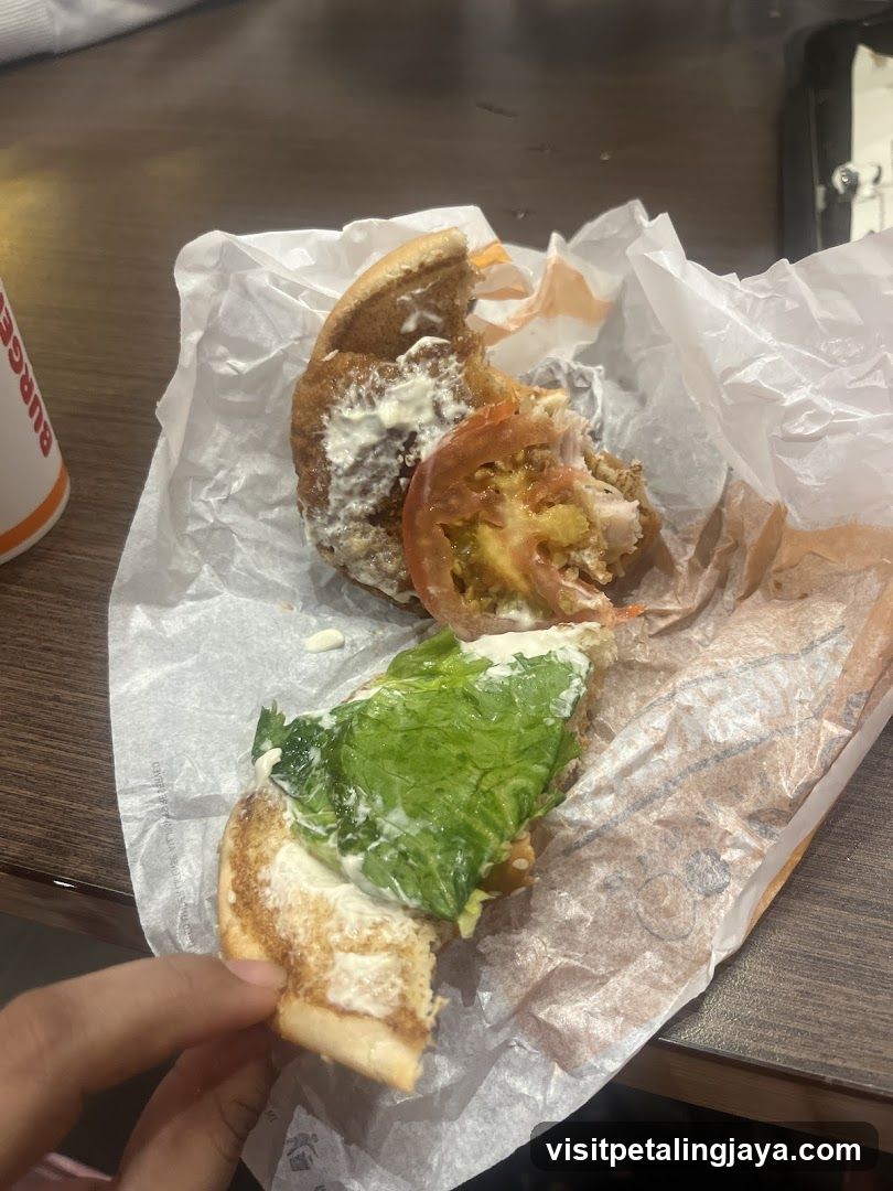 Half-eaten sandwich on wax paper