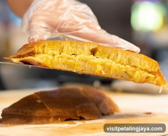 Hand Holding a Slice of Bread with Glove