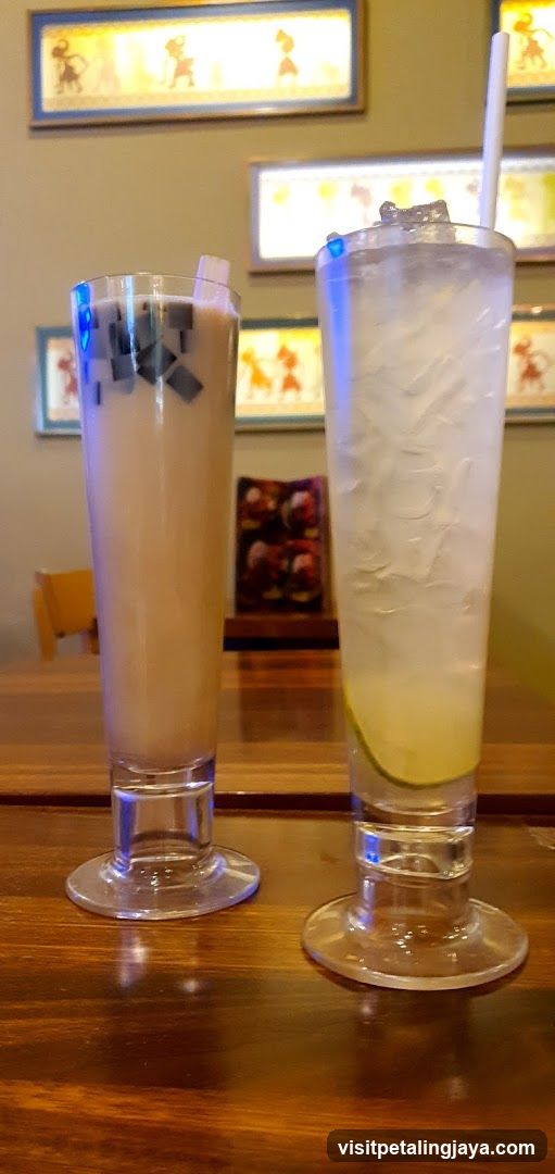 Two Tall Drinks on a Wooden Table
