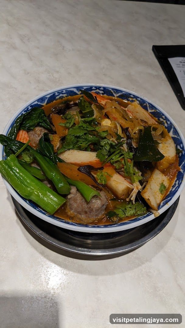 Bowl of Hot Pot Soup with Vegetables and Meatballs
